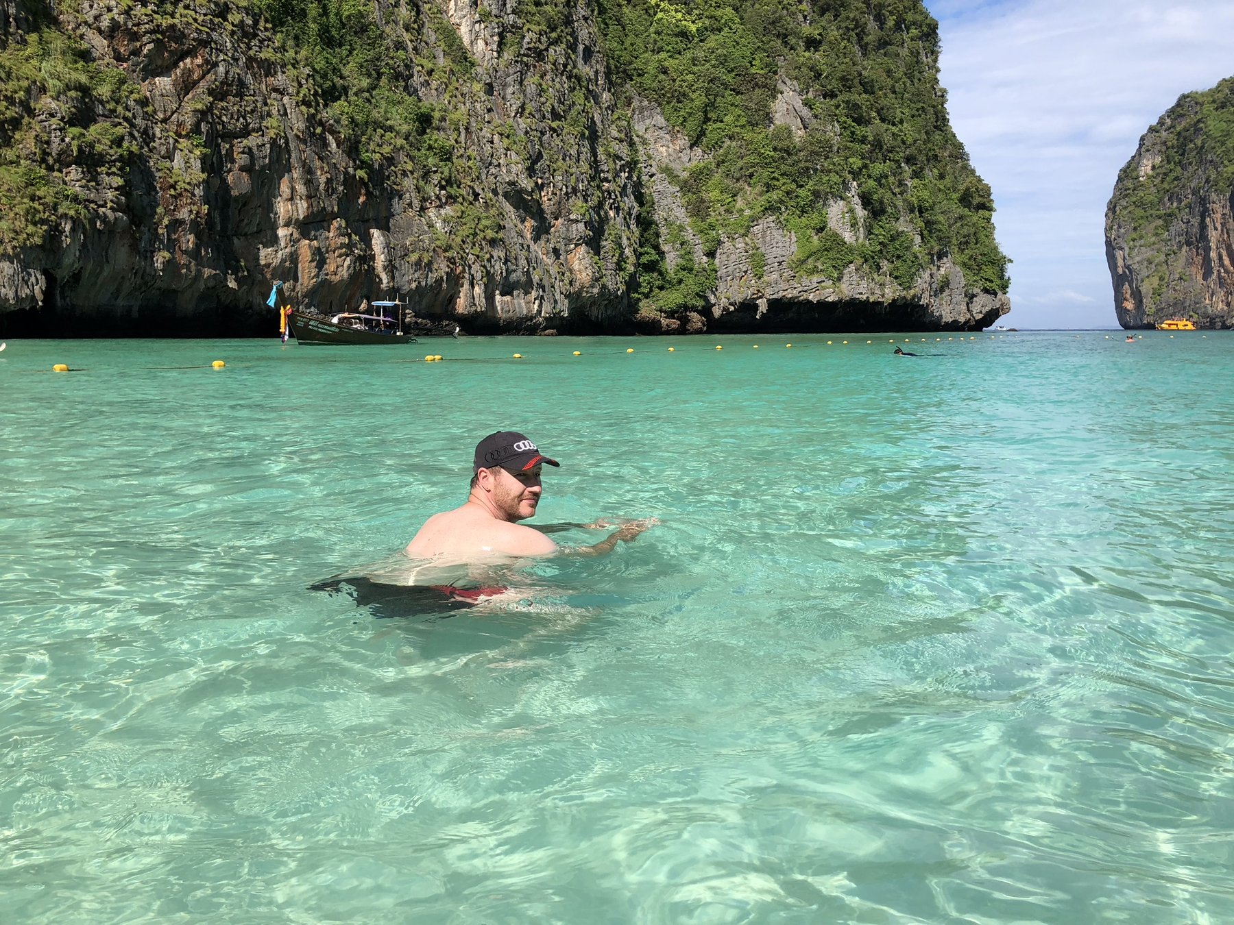 Phi Phi Islands — Swimming in brilliantly clear water below the limestone cliffs.