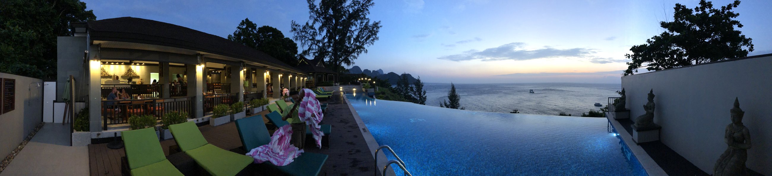 Ko Lanta — An evening panorama from the pool as the sky turns blue and gold.