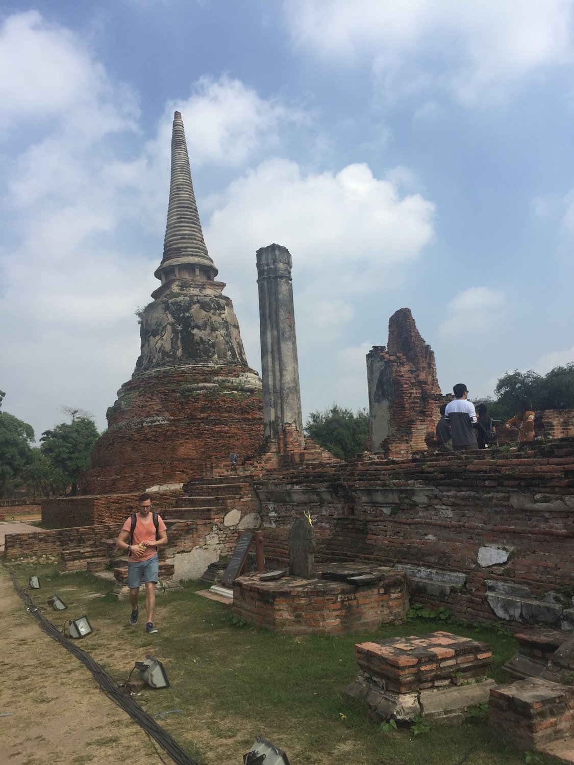 Ayutthaya — Ancient chedis and brickwork beneath a bright tropical sky.
