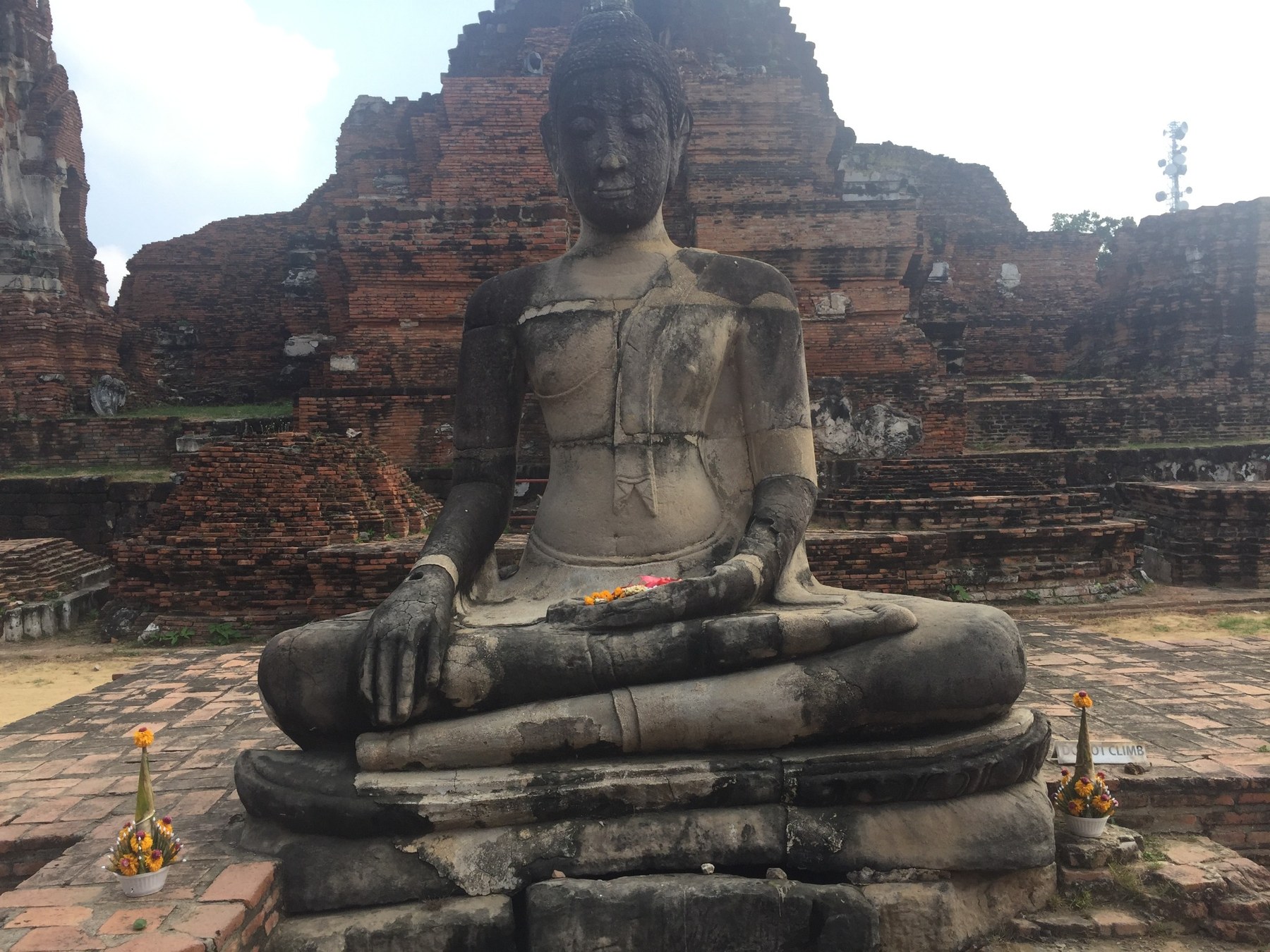 Ayutthaya — seated Buddha among ancient brick ruins